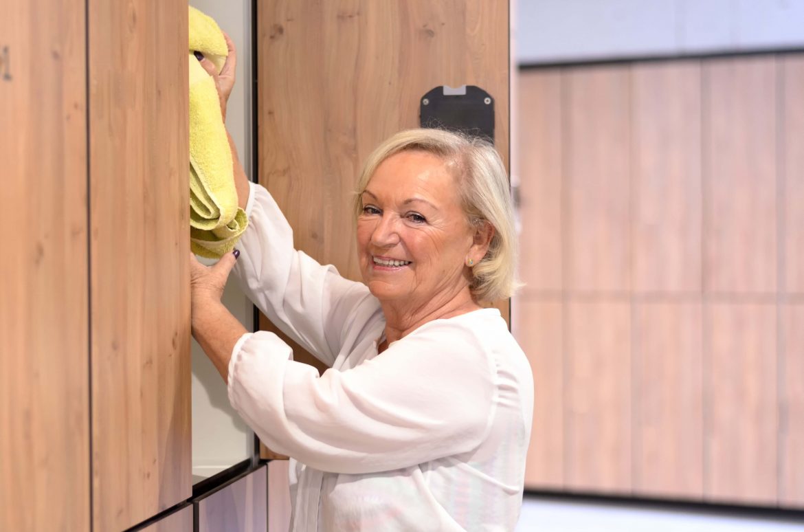 Attractive senior woman reaching into a cupboard